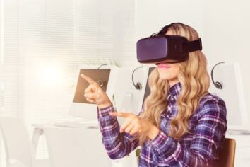 Composite image of pretty casual worker using oculus rift